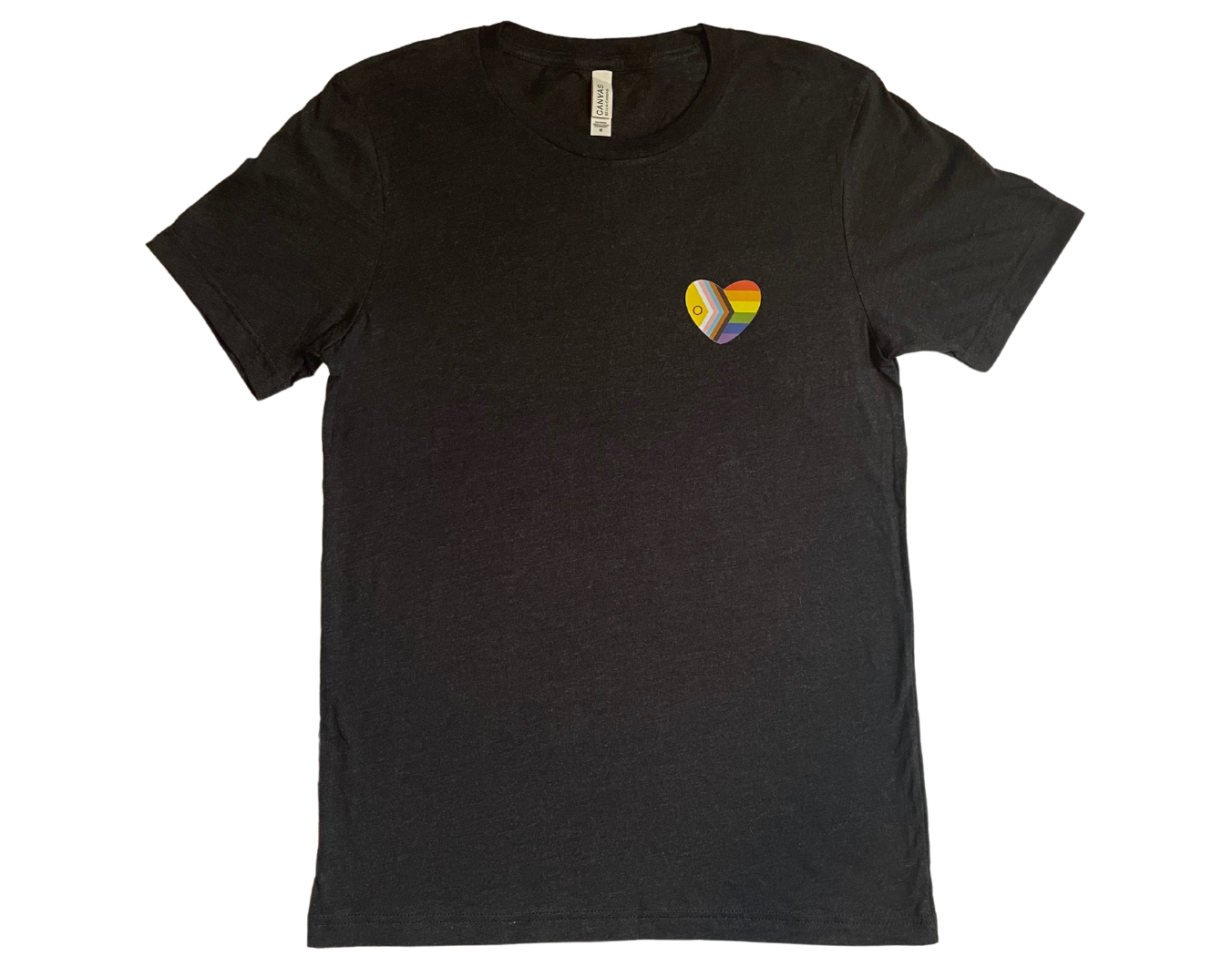 Black t-shirt is laid flat against a white background. A heart shape rainbow flag is placed over the left chest.