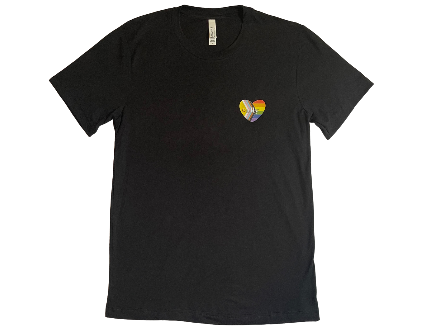 Black t-shirt is laid flat against a white background. A heart shape rainbow flag is placed over the left chest with the word ally centered amongst it.